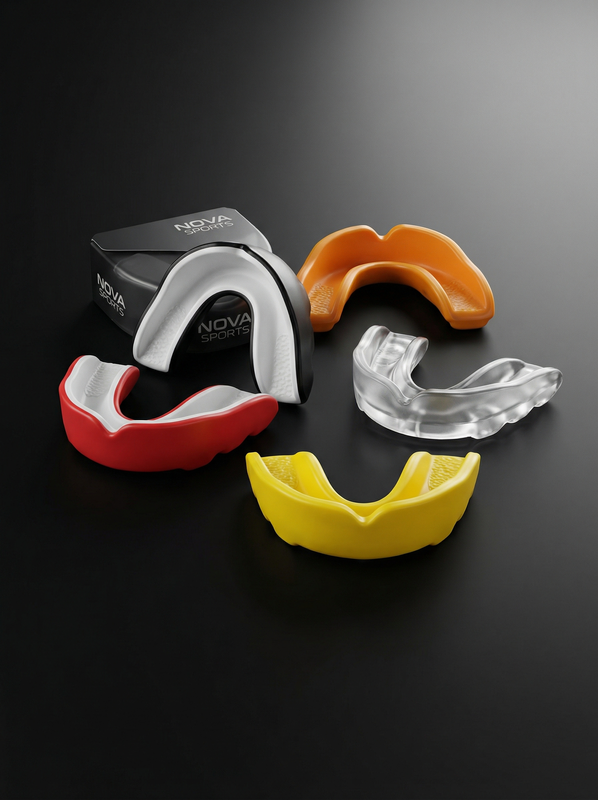Single-layer Nova gum shields in white, orange, red, yellow and black on a dark surface — Mouth Guards from Nova Sports Mauritius
