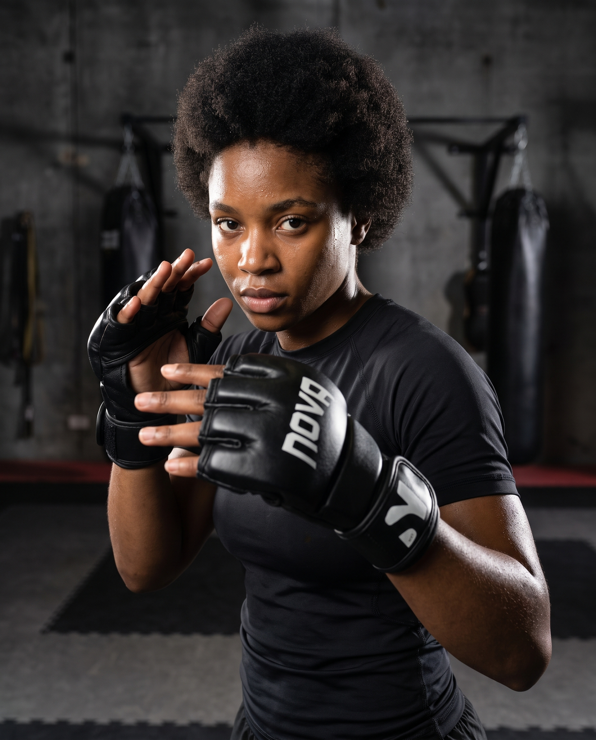 Model in open-palm guard wearing NOVA black MMA training gloves — Gloves from Nova Sports Mauritius

