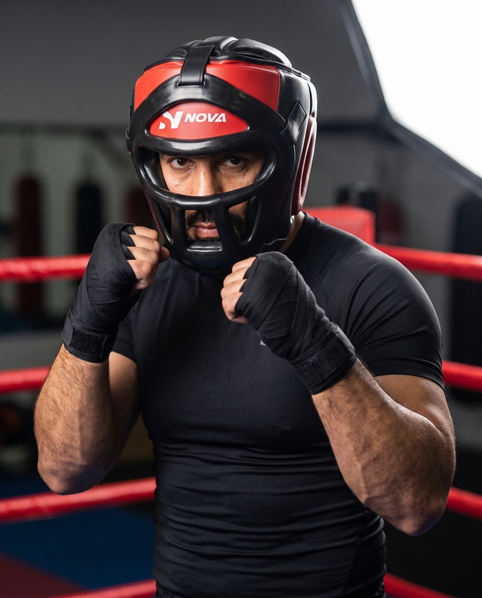 Fighter in ready stance wearing NOVA black and red head guard with removable face bar — Head Guards available in Mauritius
