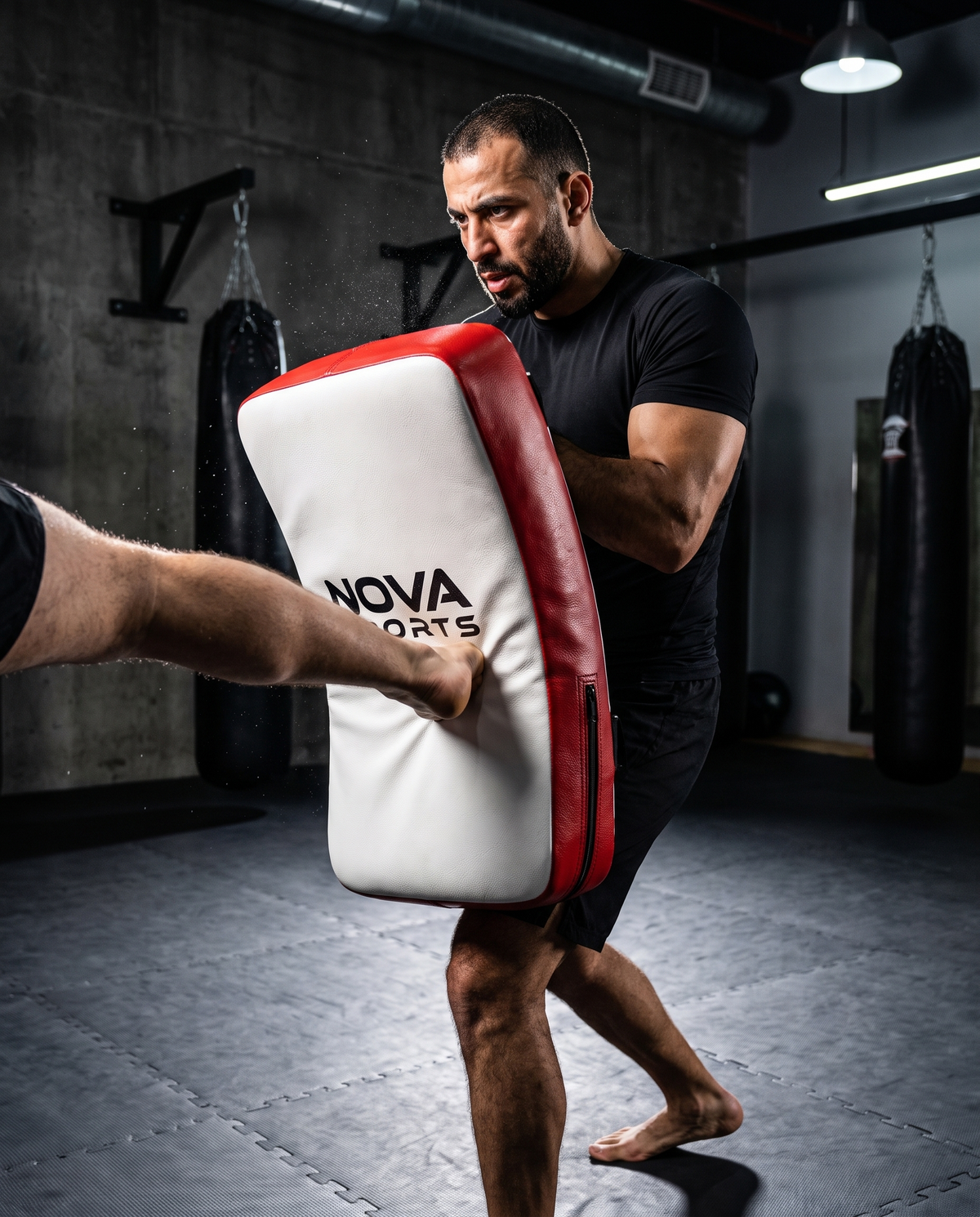 Coach bracing a NOVA heavy-duty curved kick shield as a partner lands a kick — Kick Shields from Nova Sports Mauritius
