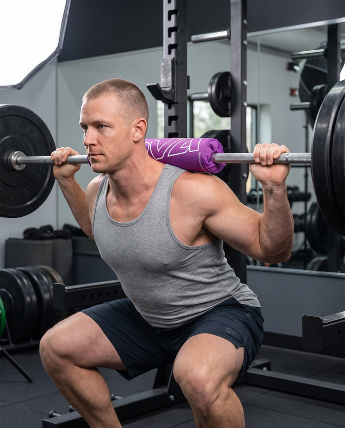 Black foam barbell squat pad with velcro closure, wrapped around a bar — Nova Sports Mauritius — Barbell Pads available in Mauritius
