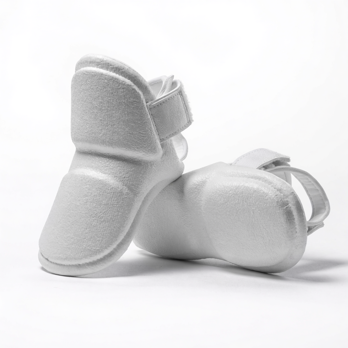 Nova Sports taekwondo foot protectors in white dipped foam, pair shown on a white background — Shin & Foot Guards from Nova Sports Mauritius
